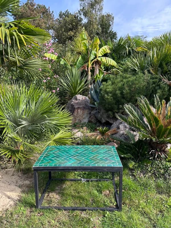 Turquoise Zellige table photographed straight on in a garden